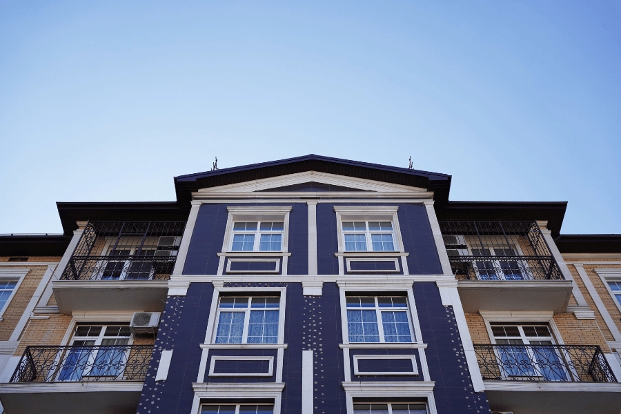 blue multi-family home with balconies and multiple floors